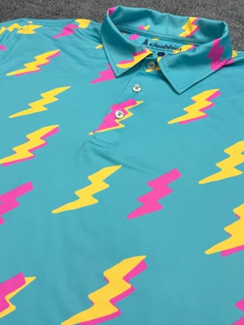 Chubbies Performance Polo Shirt Mens L Retro Turquoise Yellow Pink Lightning AOP